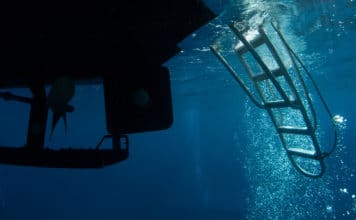 underneath the dive boat where scuba divers return. bubbles can often be seen cascading into the ladder rudder and propeller