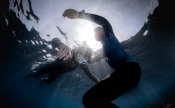 Underwater shot of freedivers training static breath hold.